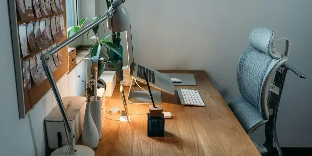 Ergonomic home office setup with a comfortable chair, standing desk, and organized workspace, promoting a healthy work environment for remote professionals.